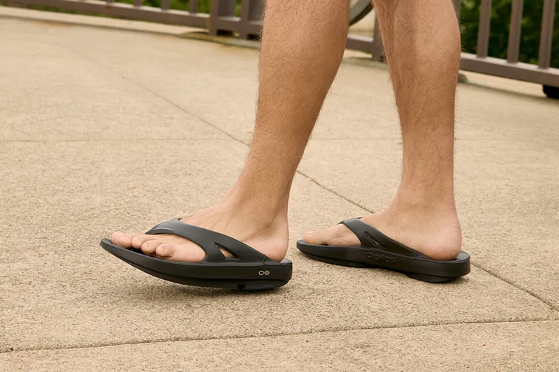 Man wearing Oofos sandal